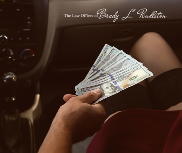 man handing money to prostitute in car